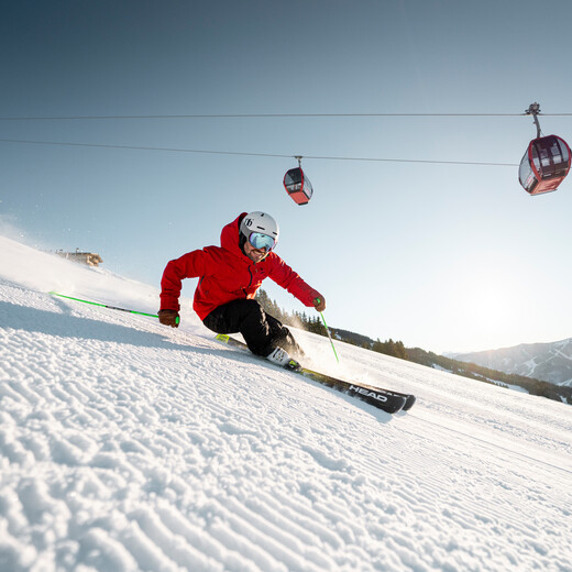 Skier on freshly prepared slope in Saalbach Hinterglemm ski resort